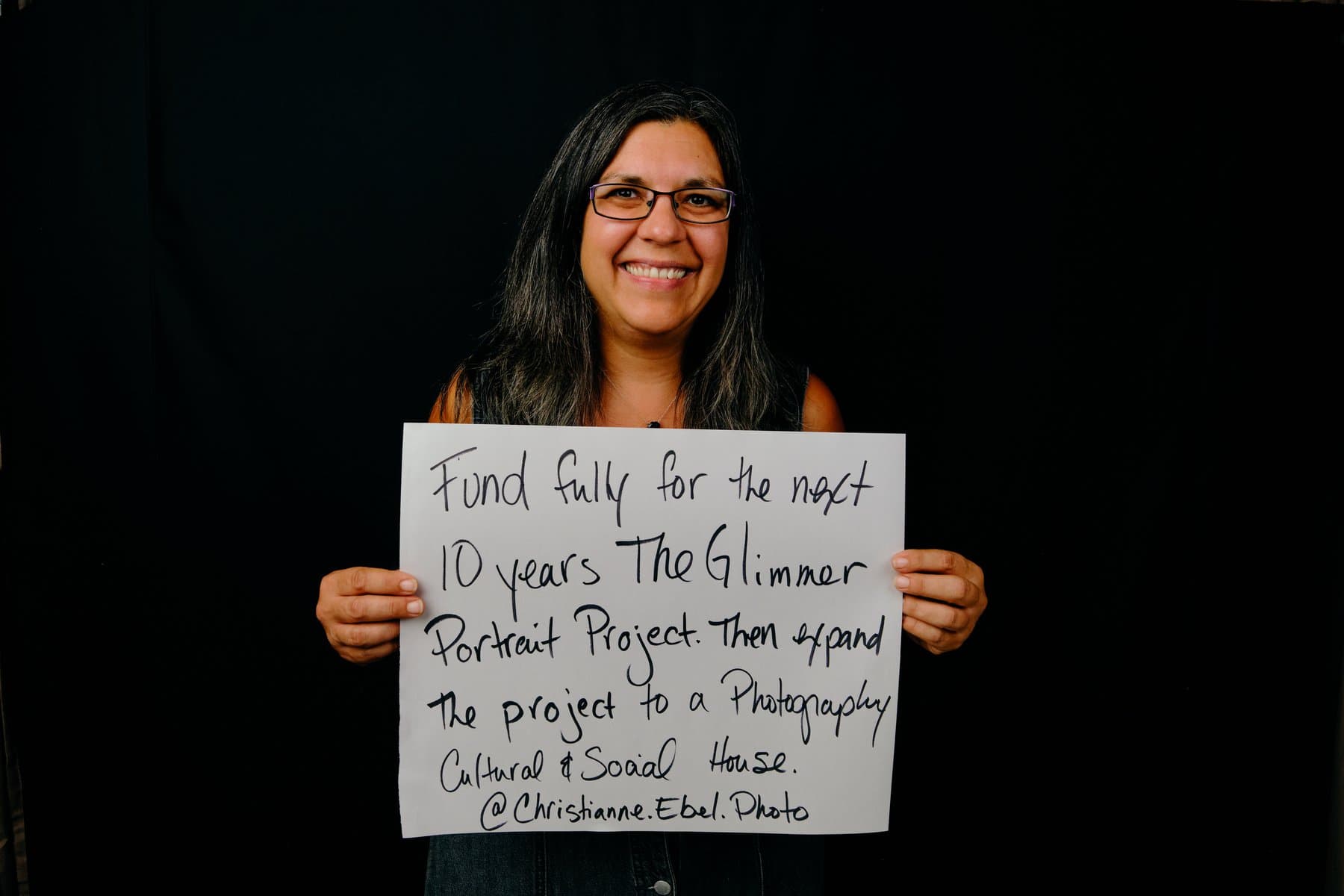 Dreams & Obstacles, August 10 — a dreamer holding their sign