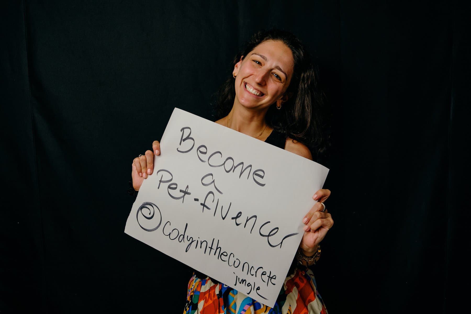 Dreams & Obstacles, August 10 — a dreamer holding their sign